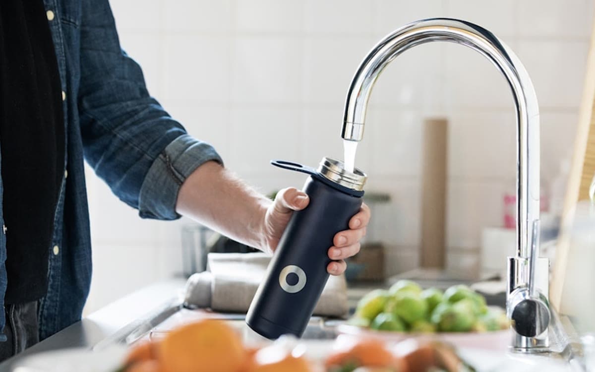 Filling a bottle at a kitchen tap.